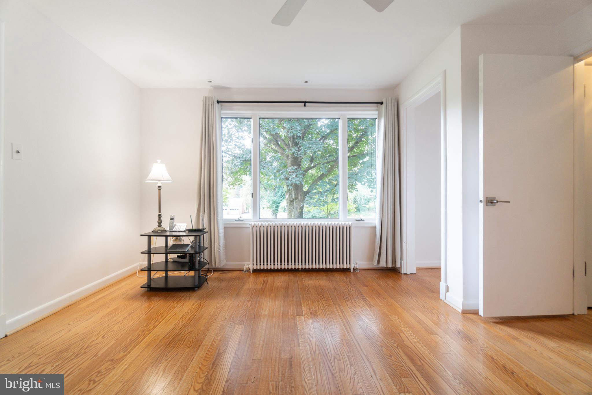14612 Fairacres Road Silver Spring, MD 20905 - Photo 10 of 53 an empty room with wooden floor and furniture