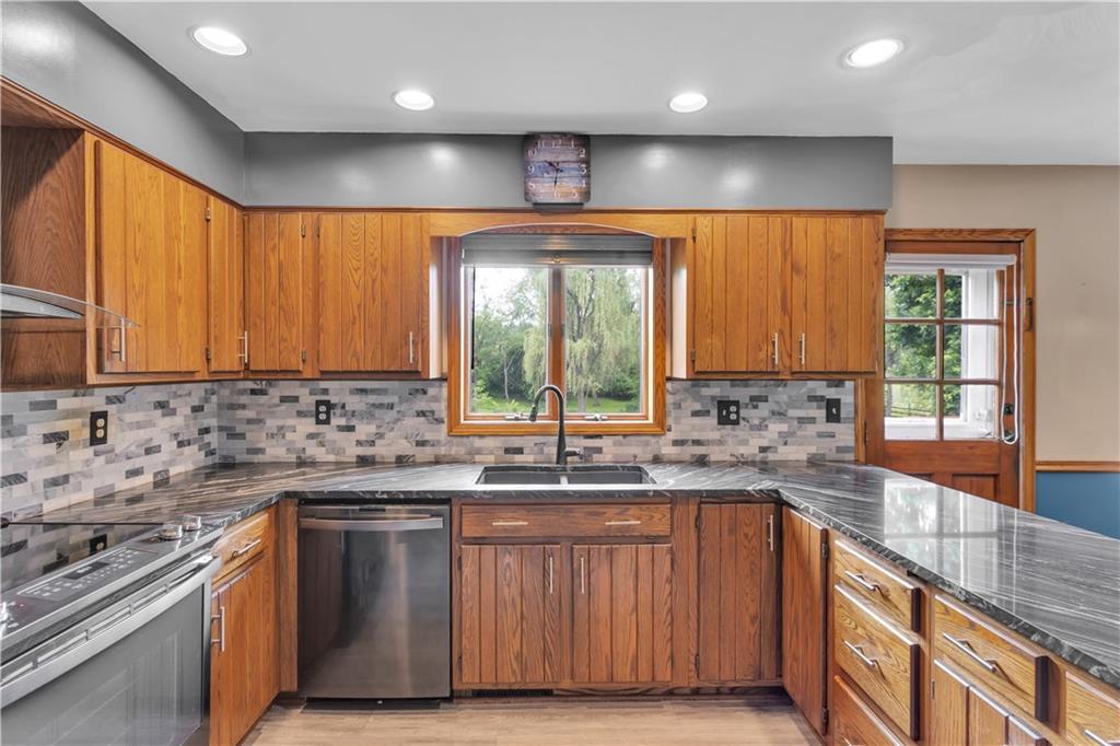 206 Brook Hollow Road Mount Pleasant, PA 15666 - Photo 22 of 41 a kitchen with a sink stove and cabinets