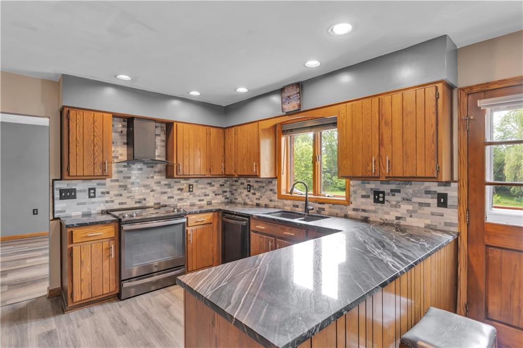 206 Brook Hollow Road Mount Pleasant, PA 15666 - Photo 27 of 41 a kitchen with stainless steel appliances granite countertop a sink a stove a counter space and cabinets