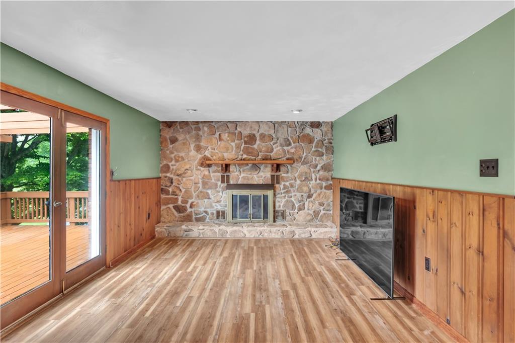 206 Brook Hollow Road Mount Pleasant, PA 15666 - Photo 28 of 41 a view of a livingroom with wooden floor and a fireplace
