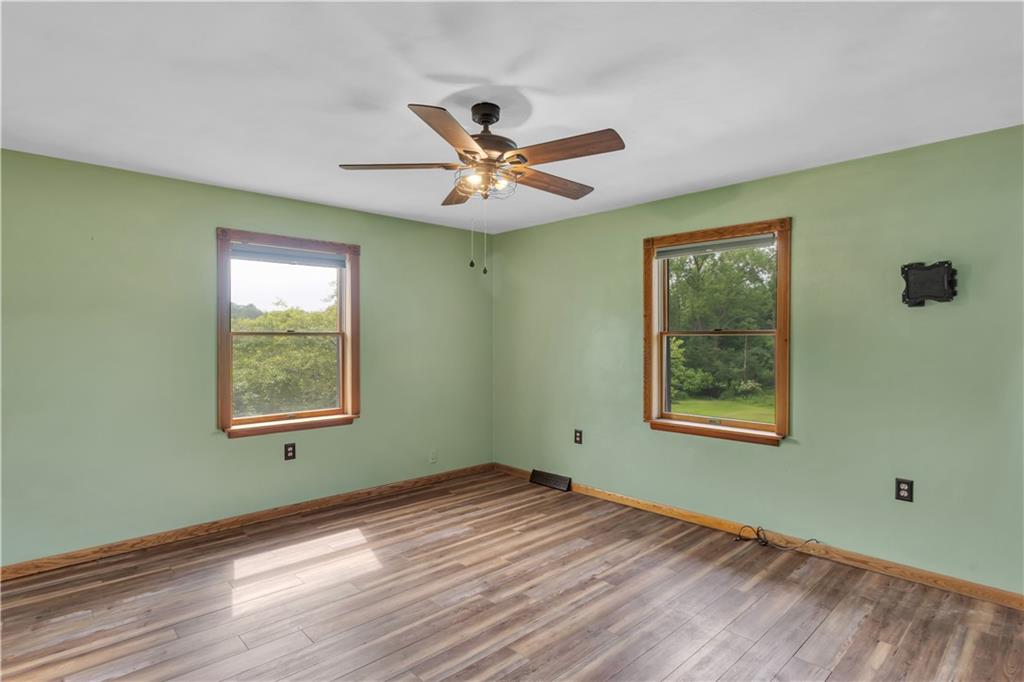 206 Brook Hollow Road Mount Pleasant, PA 15666 - Photo 33 of 41 a view of an empty room with window and wooden floor