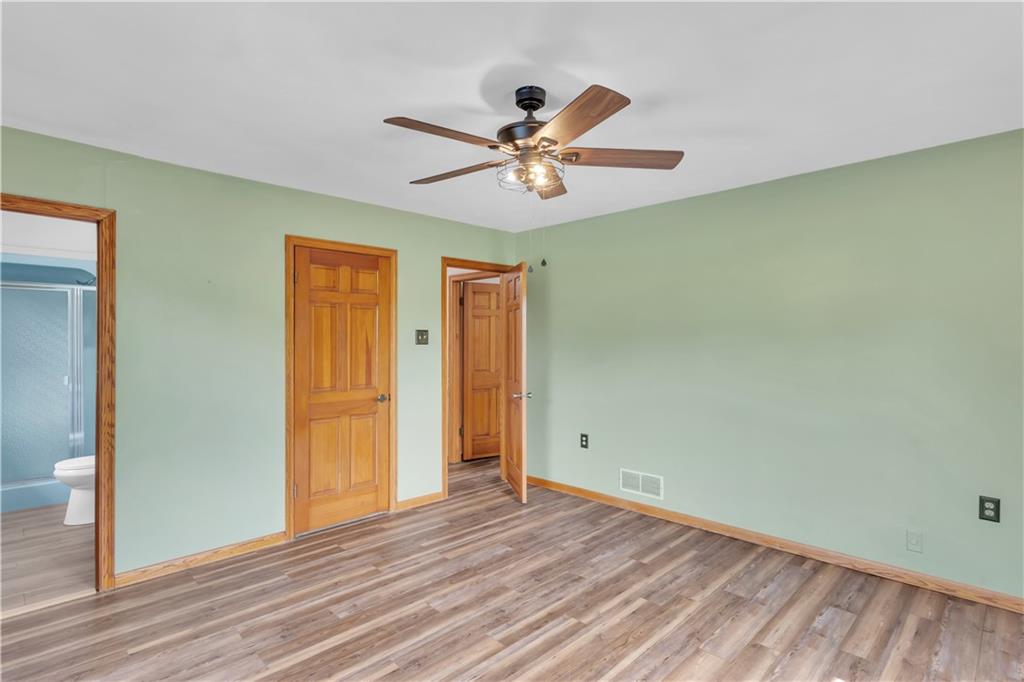 206 Brook Hollow Road Mount Pleasant, PA 15666 - Photo 35 of 41 a view of a room with wooden floor and ceiling fan