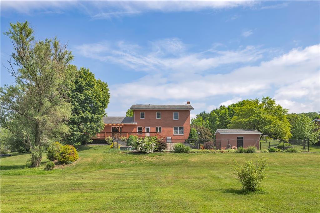 206 Brook Hollow Road Mount Pleasant, PA 15666 - Photo 6 of 41 a front view of a house with a garden
