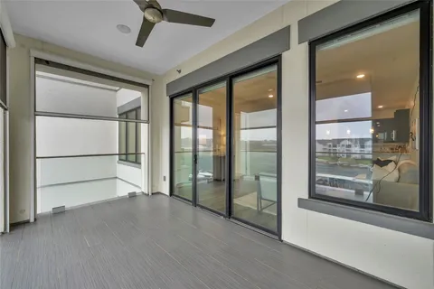 a view of an empty room with a sliding door and a window