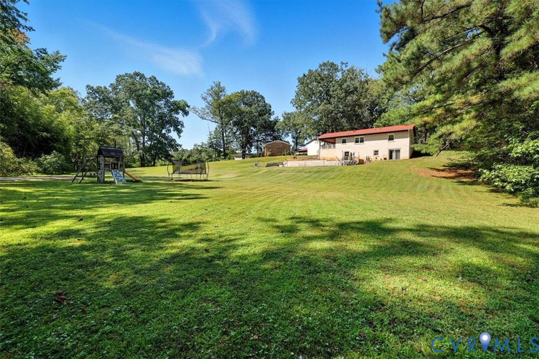 237 Craddock Street Boydton, VA 23917 - Photo 9 of 41 View of grassy yard featuring a playground