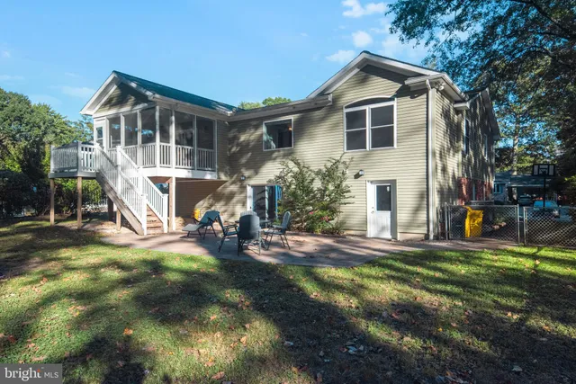 a view of a house with backyard porch and sitting area