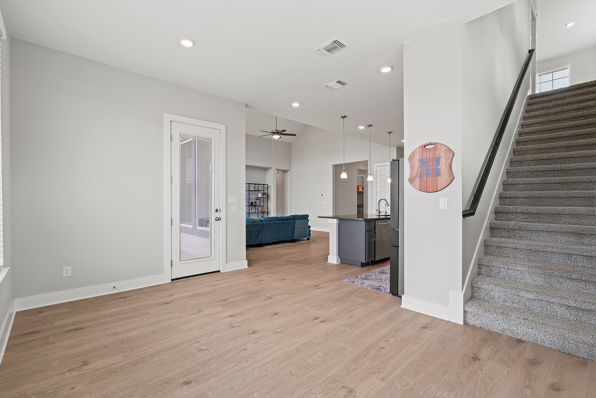 2112 Tobiano Trace Georgetown, TX 78633 - Photo 27 of 40 Unfurnished living room featuring light wood finished floors, recessed lighting, stairway, and a ceiling fan