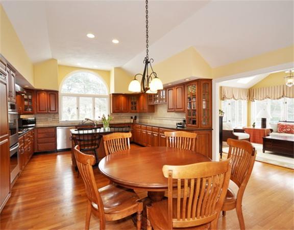 15 Garland Road Lincoln, MA 01773 - Photo 8 of 21 a dining room with stainless steel appliances granite countertop a table chairs and a living room