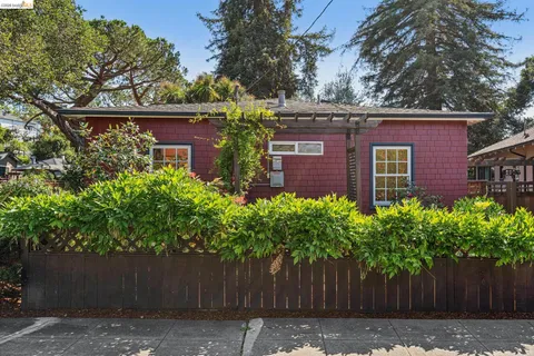 a view of a house with wooden fence