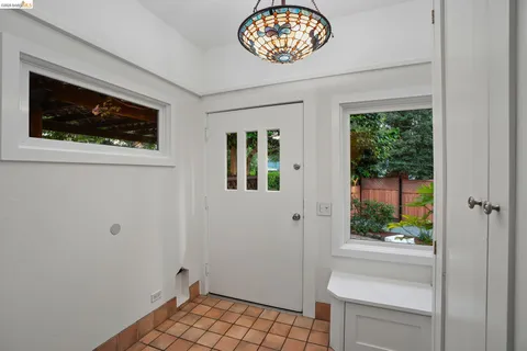 a kitchen with a sink a counter and chairs in it