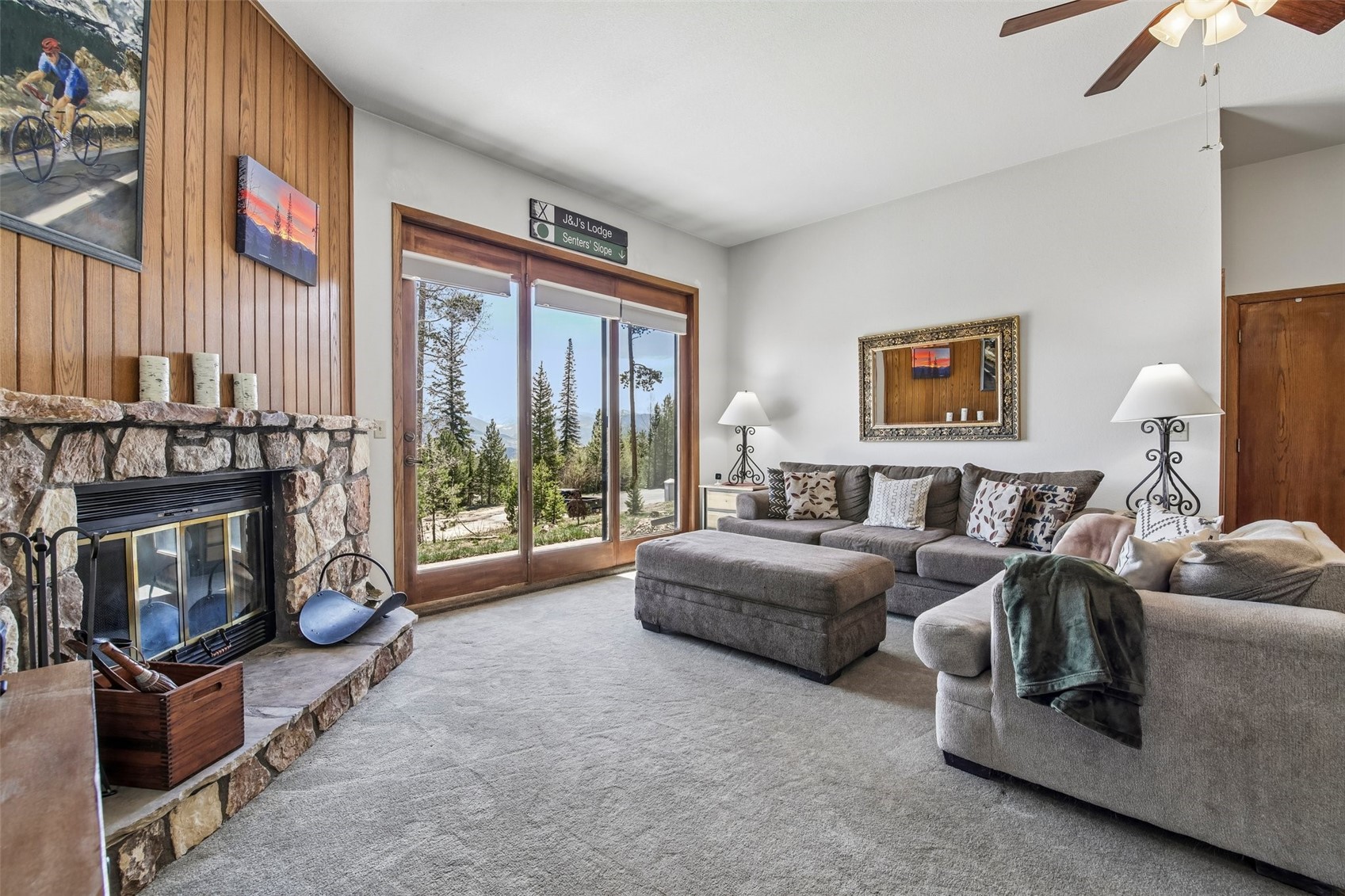 89310 Ryan Gulch Road, Unit 103 Silverthorne, CO 80498 - Photo 2 of 48 a living room with furniture a large window and a fireplace