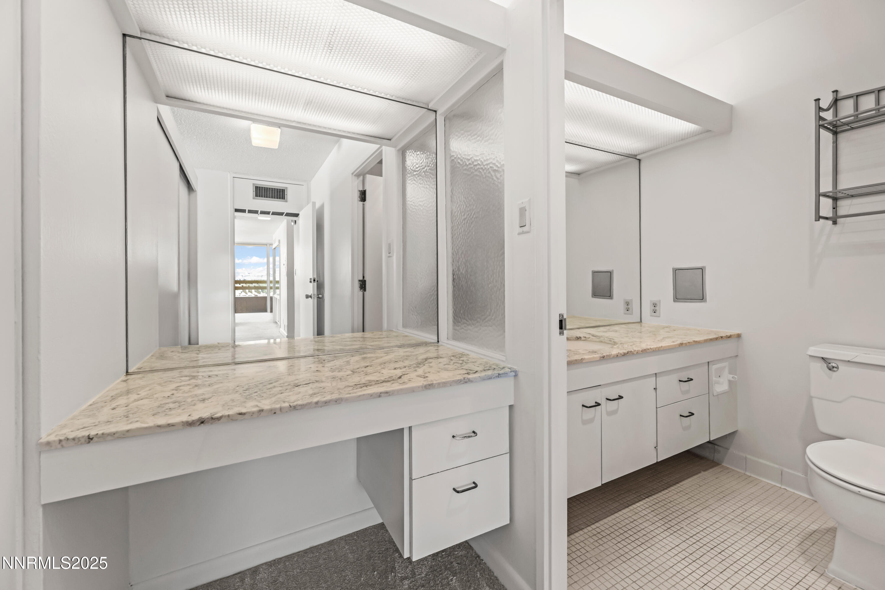 100 North Arlington Avenue, Unit 21K Reno, NV 89501 - Photo 11 of 24 a bathroom with a granite countertop sink mirror and toilet