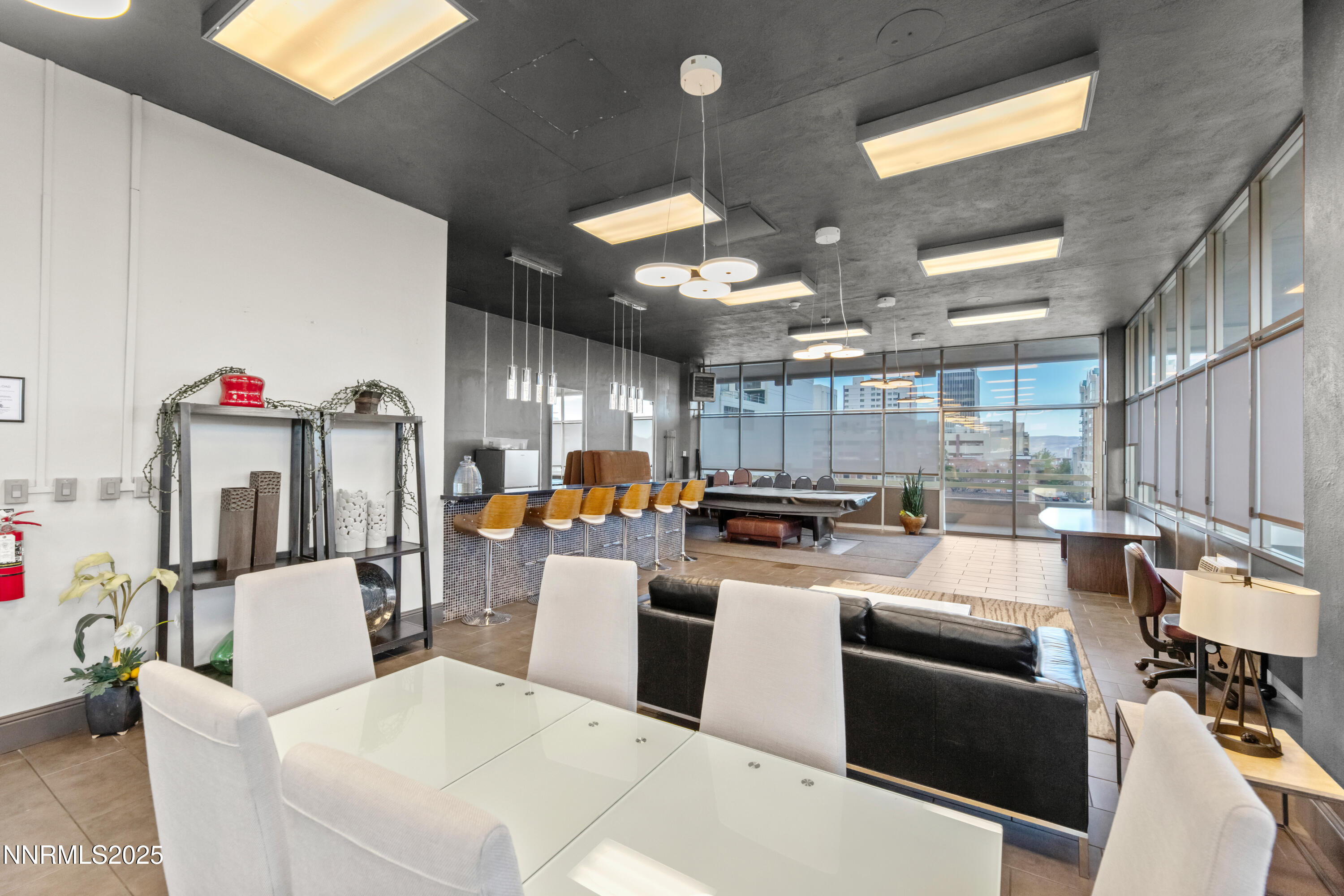 100 North Arlington Avenue, Unit 21K Reno, NV 89501 - Photo 23 of 24 a kitchen with stainless steel appliances kitchen island granite countertop a refrigerator a stove and a sink with living room