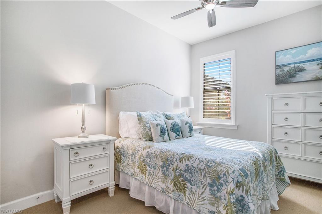 7674 Jacaranda Lane Naples, FL 34114 - Photo 14 of 45 a bedroom with a bed and a window