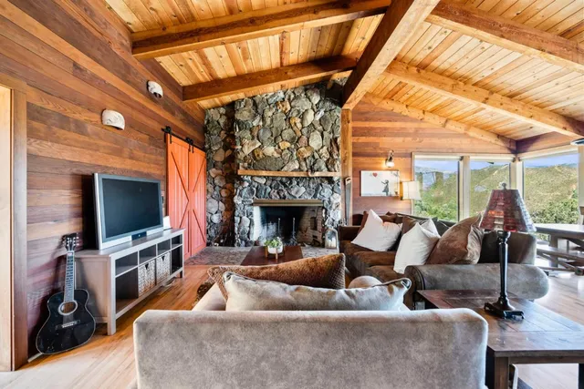a view of a dining room with furniture a chandelier and wooden floor