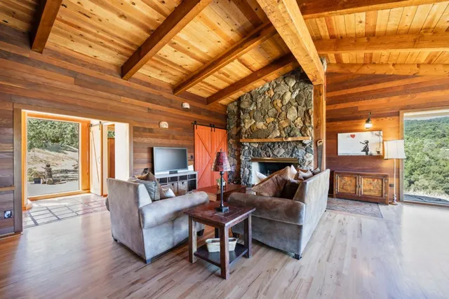 a dining room with wooden floor furniture and a chandelier
