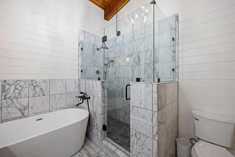 a spacious bathroom with a double vanity sink mirror and toilet