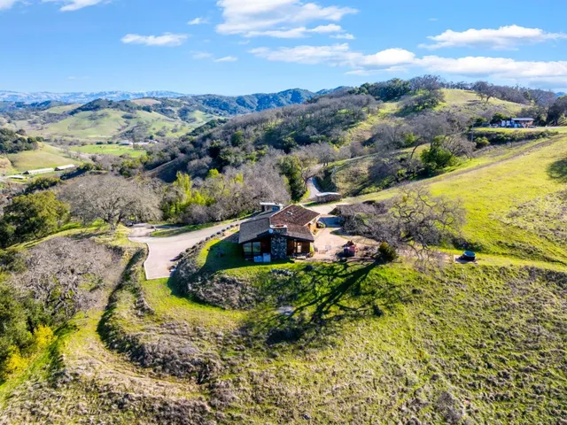 an aerial view of a house with yard