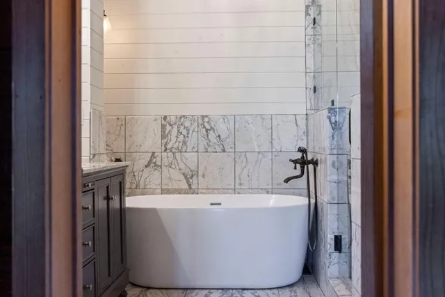a view of a patio with dining table and chairs with wooden floor and fence