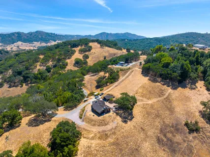 a view of a house with a yard and lake view