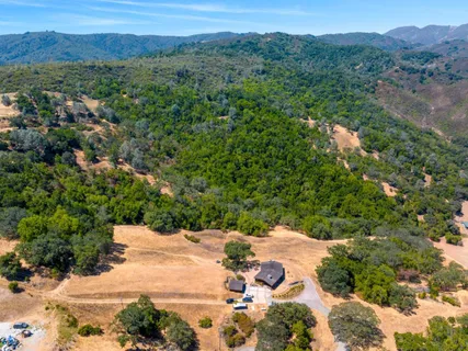 an aerial view of a house with a yard basket ball court