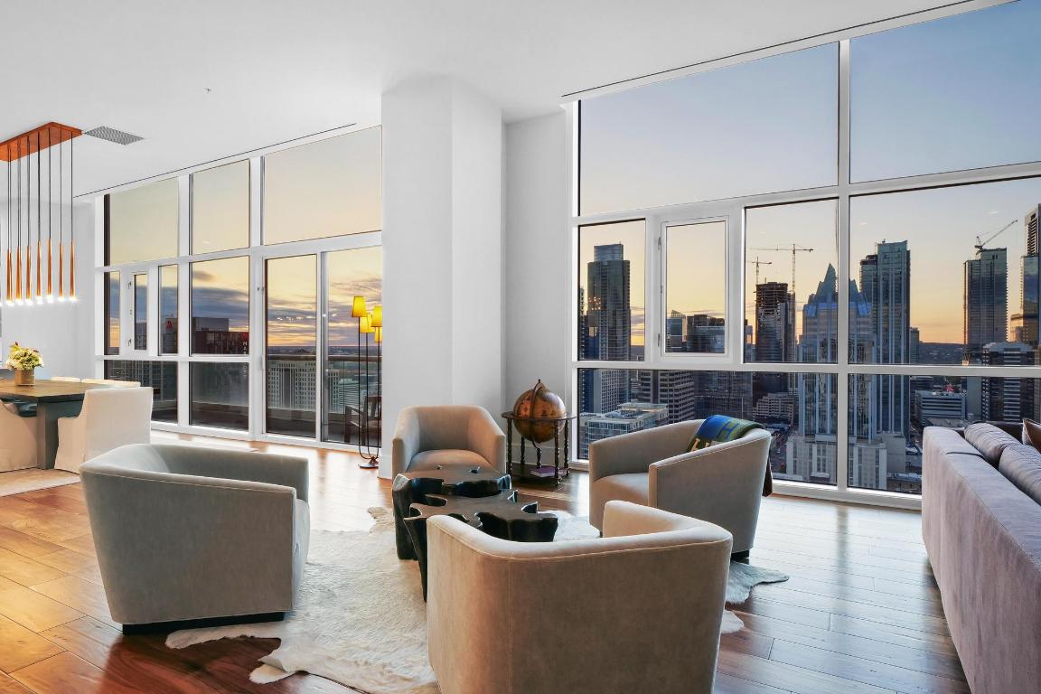 a living room with furniture and a floor to ceiling window