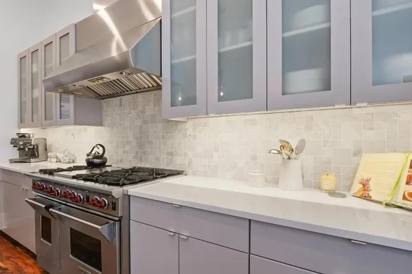 a white stove top oven sitting inside of a kitchen