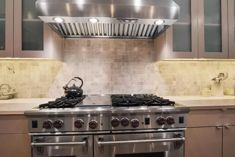 a kitchen with a stove and cabinets