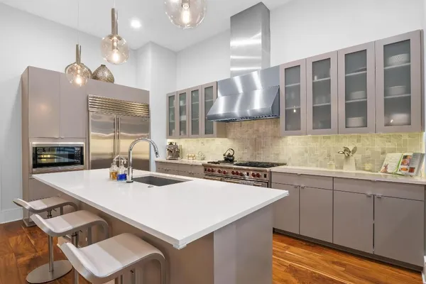 a kitchen with a sink a stove and cabinets