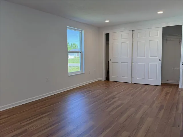 a view of room with hardwood floor and window