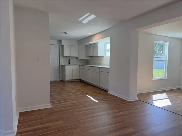 a room with wooden floors and window