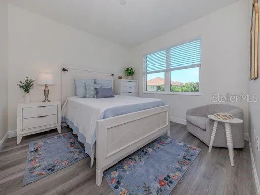 a bedroom with a bed and a chair