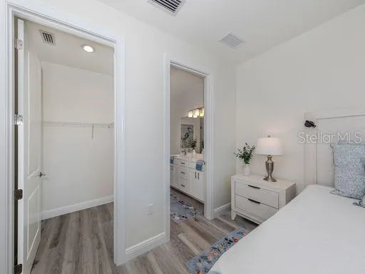 a spacious bedroom with a bed and a view of bathroom