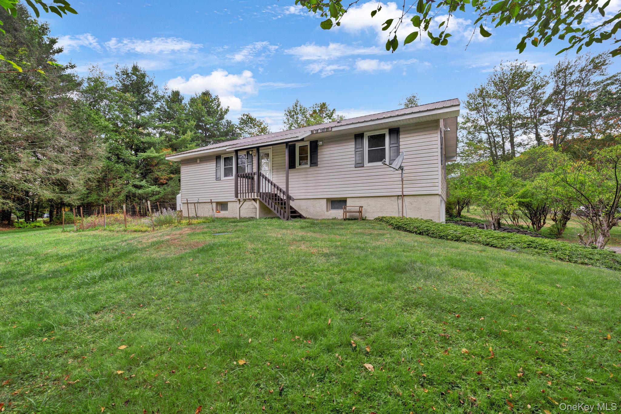 148 Moore Road Woodbourne, NY 12788 - Photo 29 of 36 a front view of house with yard and green space