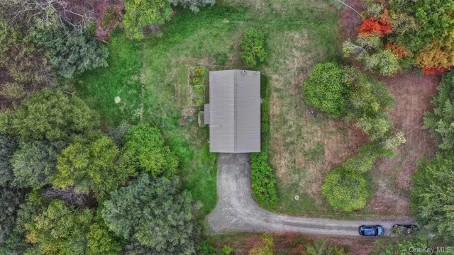 an aerial view of a house with a yard