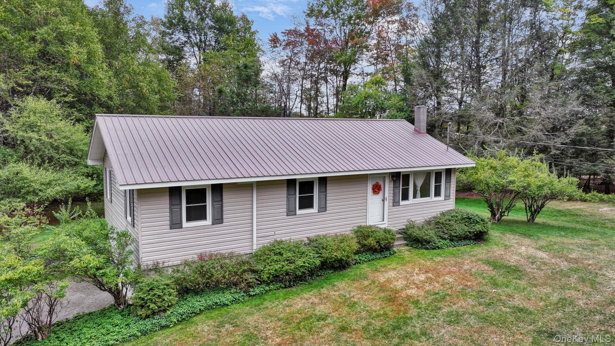 148 Moore Road Woodbourne, NY 12788 - Photo 4 of 36 a view of a house with a yard plants and large tree