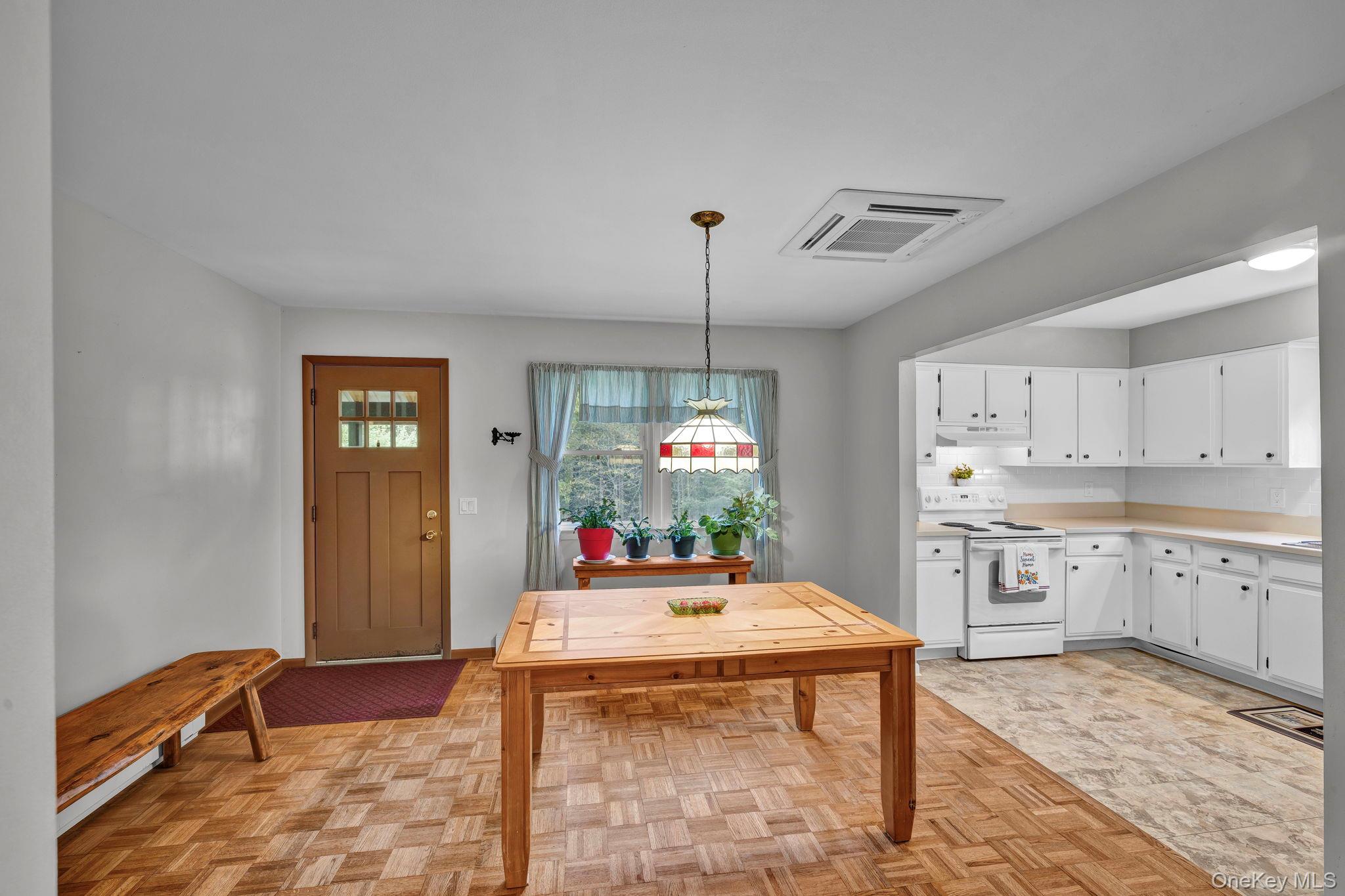148 Moore Road Woodbourne, NY 12788 - Photo 8 of 36 a kitchen with a refrigerator a stove a sink dishwasher with a dining table and chairs
