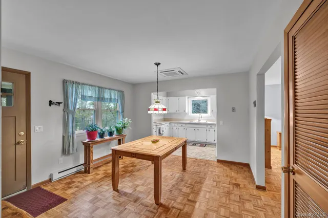 a dining room with a table and chairs