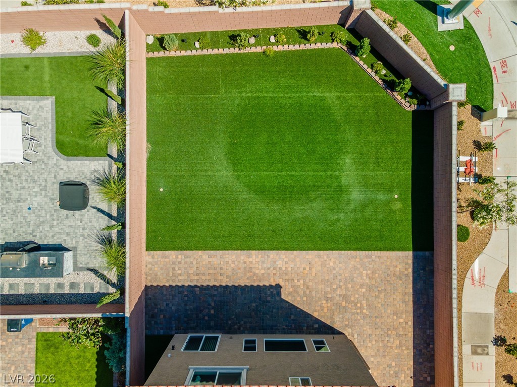 5510 Ripple Ridge Avenue Las Vegas, NV 89139 - Photo 5 of 45 An aerial view captures the meticulously landscaped backyard with a spacious green lawn.