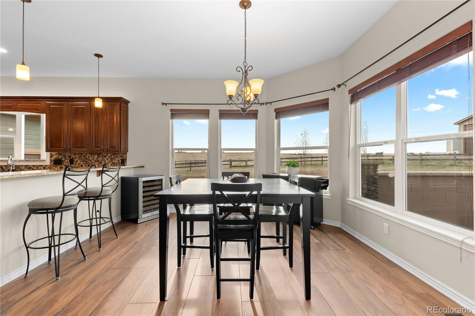 41900 East Muirfield Loop Elizabeth, CO 80107 - Photo 11 of 26 a view of a dining room with furniture window and wooden floor