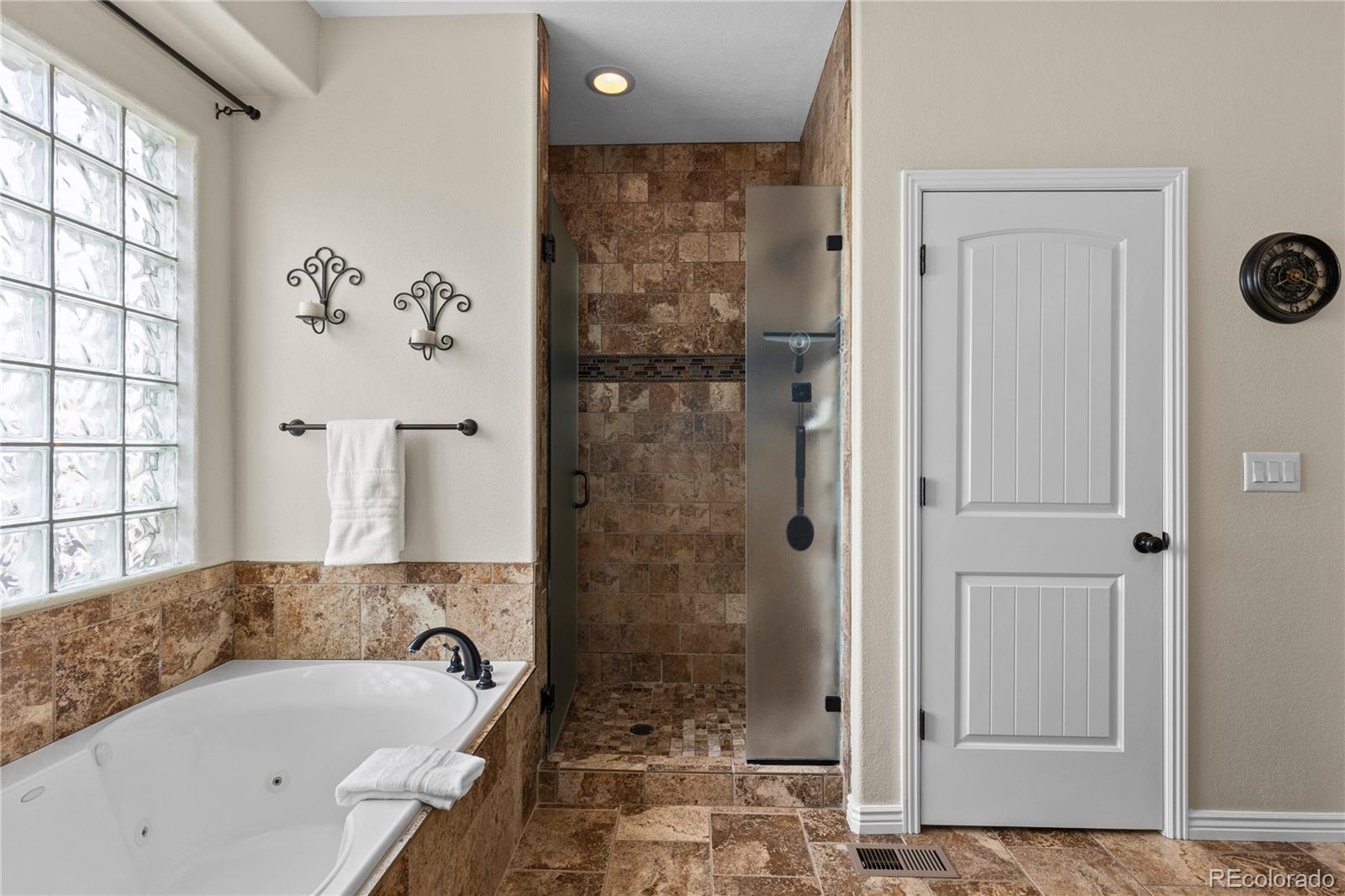 41900 East Muirfield Loop Elizabeth, CO 80107 - Photo 15 of 26 a bathroom with a bathtub and a shower