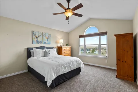 a bedroom with a large bed and a chandelier