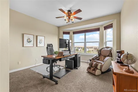 a work room with furniture and large windows