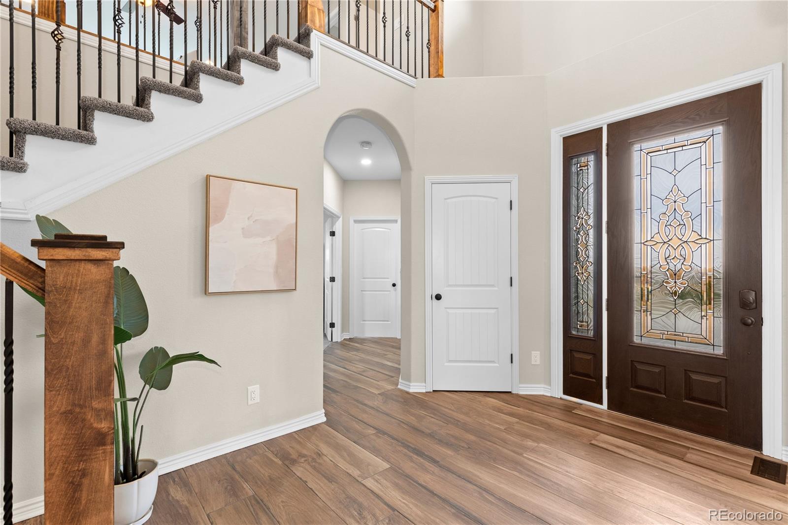 41900 East Muirfield Loop Elizabeth, CO 80107 - Photo 3 of 26 a view of a hallway with entryway wooden floor and front door
