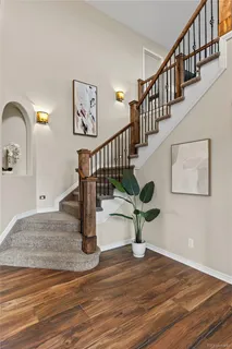 a view of entryway and hall with wooden floor