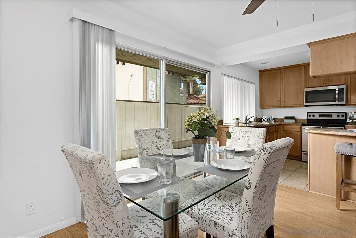 615 Fredricks Avenue, Unit 159 Oceanside, CA 92058 - Photo 11 of 26 a dining room with furniture a window and kitchen view