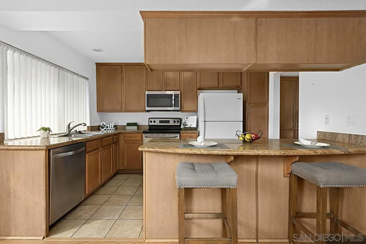 615 Fredricks Avenue, Unit 159 Oceanside, CA 92058 - Photo 12 of 26 a kitchen with stainless steel appliances granite countertop a sink and cabinets