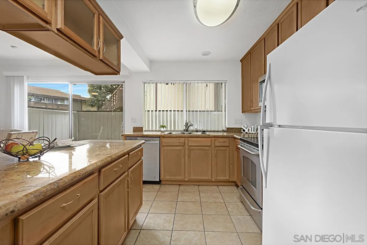 615 Fredricks Avenue, Unit 159 Oceanside, CA 92058 - Photo 14 of 26 a kitchen with a sink window and cabinets