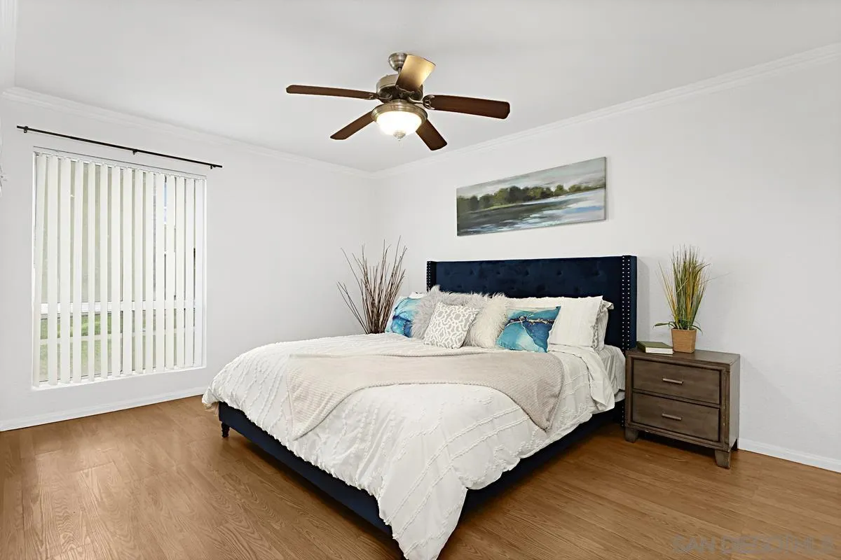 615 Fredricks Avenue, Unit 159 Oceanside, CA 92058 - Photo 16 of 26 a bedroom with a bed and a large window