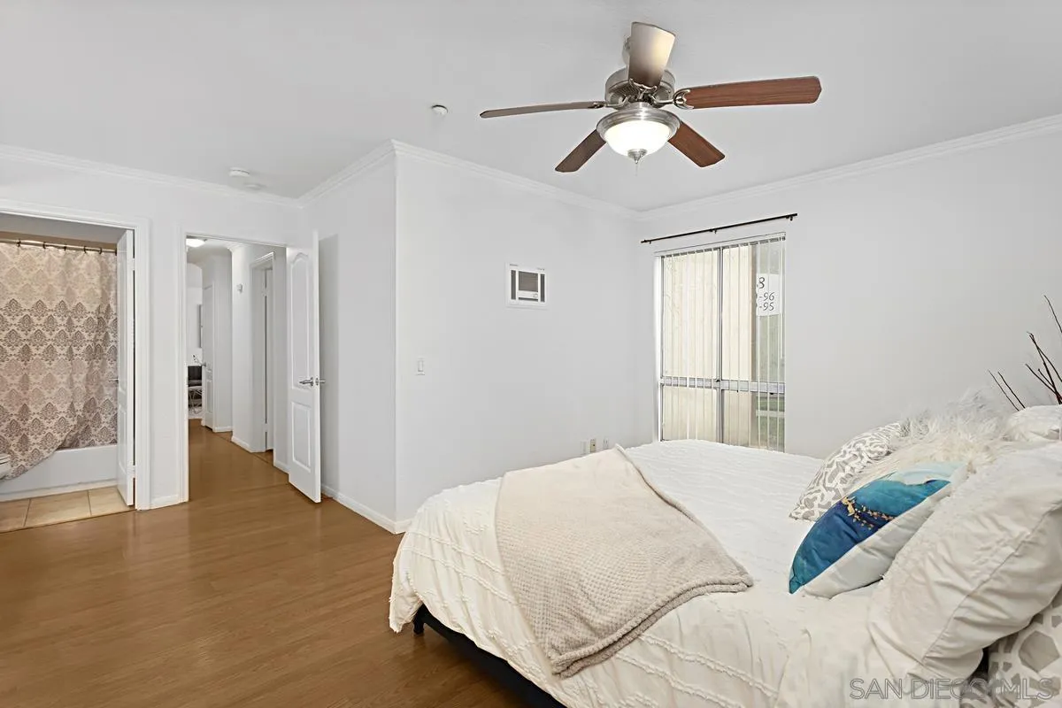615 Fredricks Avenue, Unit 159 Oceanside, CA 92058 - Photo 17 of 26 a bedroom with a bed ceiling fan and a window
